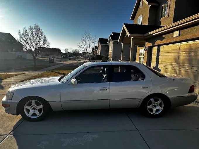 White Lexus LS sedan freshly detailed in a residential Phoenix driveway